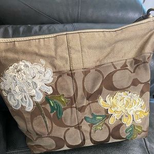Brown Coach bag with flower designs